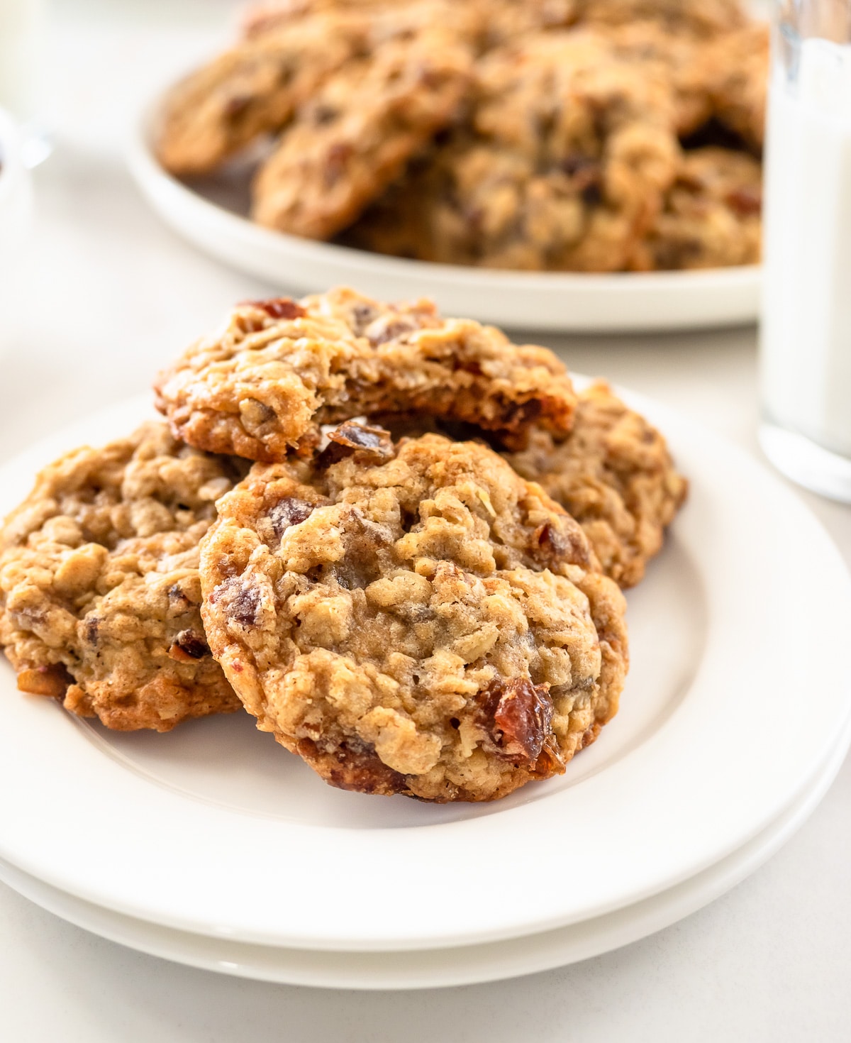 Oatmeal cookies with dates on small white dish.