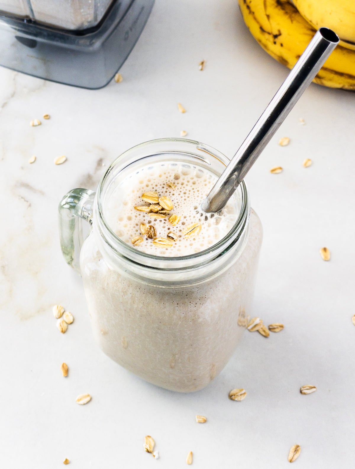 Banana oat smoothie served in mason jar.