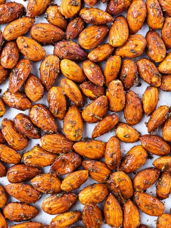 Roasted rosemary almonds on baking sheet.