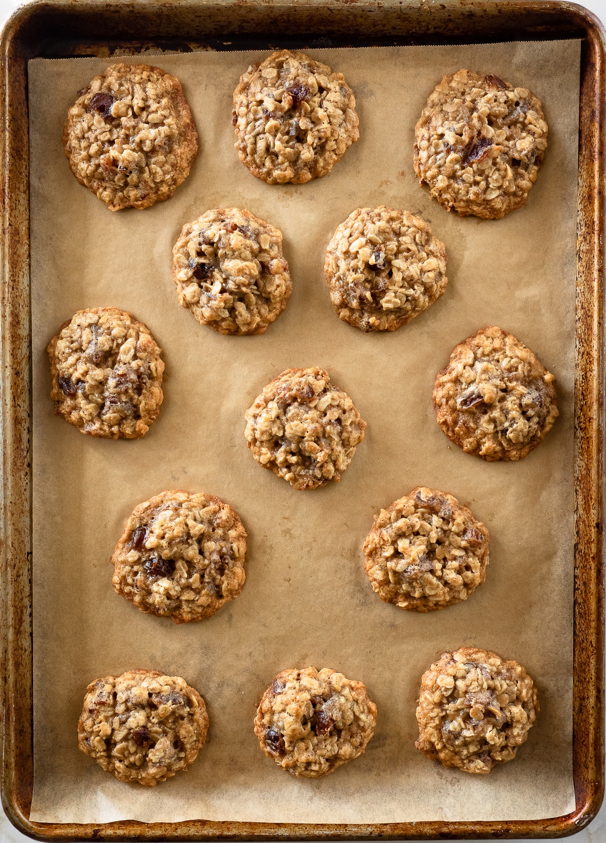 Baked oatmeal date cookies on baking sheet.