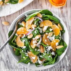 Bowl of spinach clementine salad.