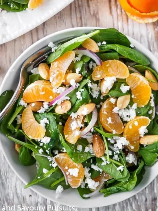 Bowl of spinach clementine salad.