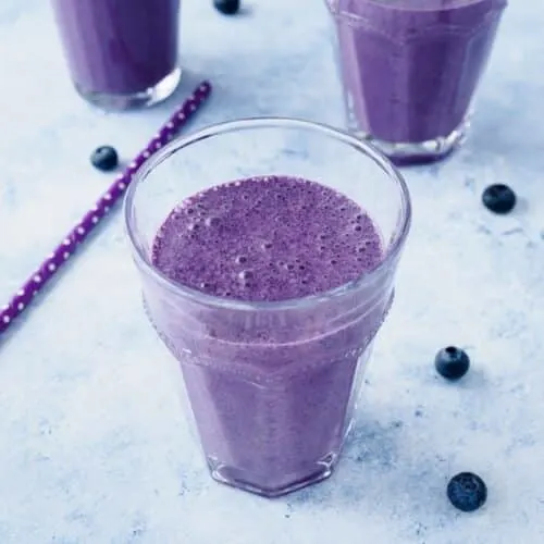 Blueberry oatmeal smoothie in glass.