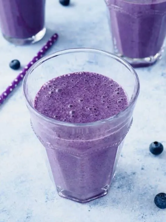 Blueberry oatmeal smoothie in glass.