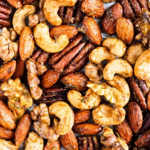 Spiced cashews, almonds, walnuts and pecans on baking sheet.