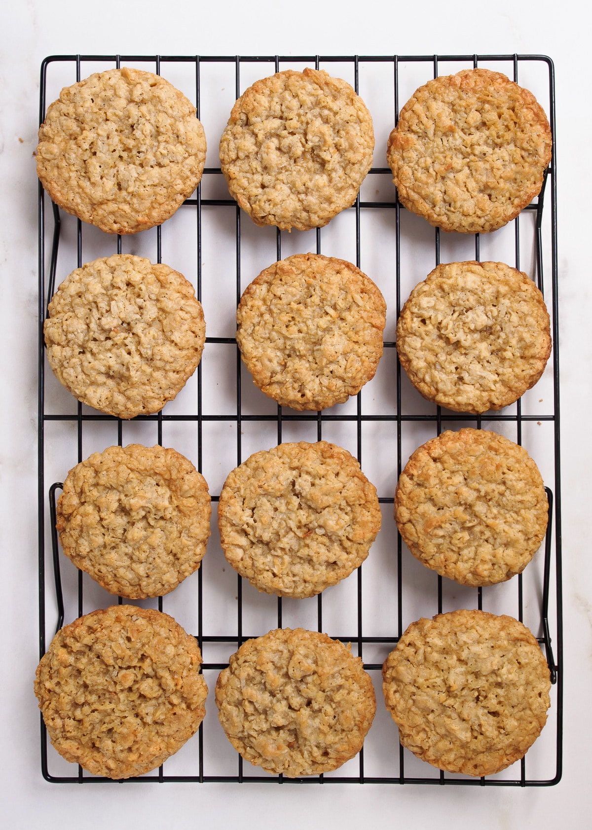 Oat coconut cookies on cooling rack.