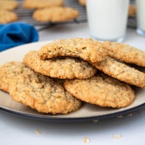 Plate of oatmeal coconut cookies with glass of milk.