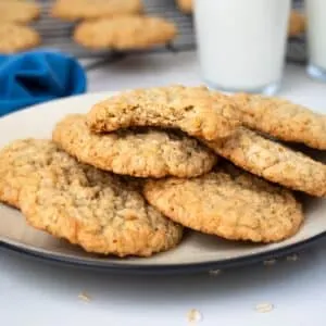 Plate of oatmeal coconut cookies with glass of milk.