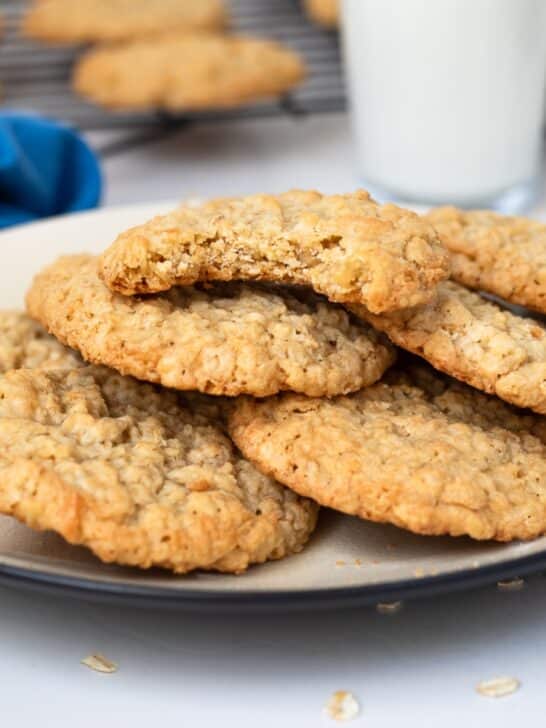 Plate of oatmeal coconut cookies with glass of milk.