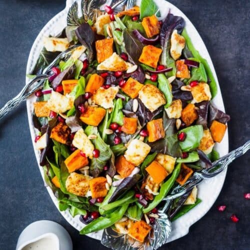 Platter of roasted sweet potato salad topped with Halloumi cheese.