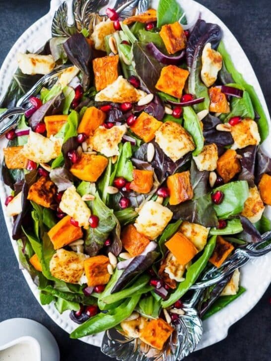 Platter of roasted sweet potato salad topped with Halloumi cheese.