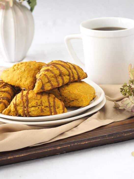 Pumpkin scones drizzled with espresso on dish.