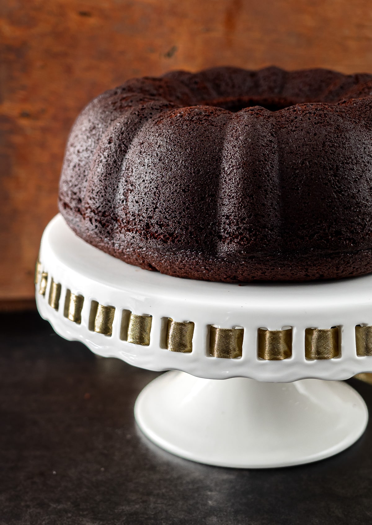 Chocolate stout bundt cake on cake stand.