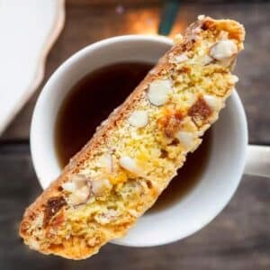 Apricot and almond biscotti on top of cup of tea.