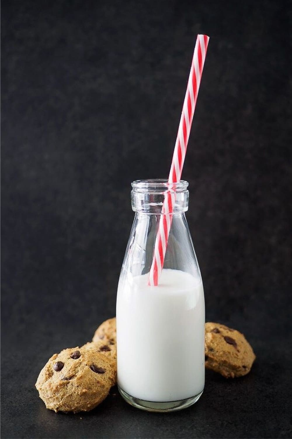 Chickpea chocolate chip cookies served with a small bottle of milk.