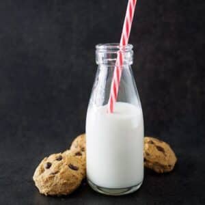 Chickpea chocolate chip cookies with a small bottle of milk.