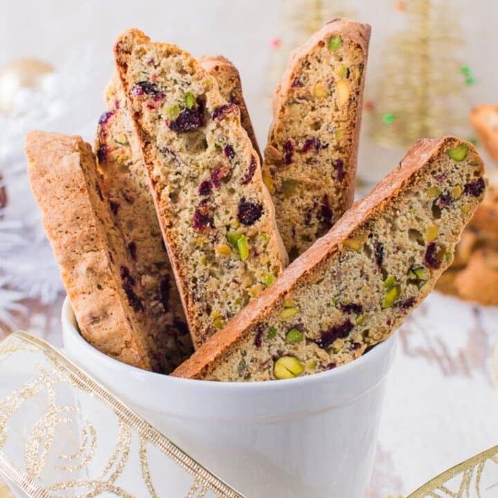 Pistachio and Cranberry Biscotti placed in large mug.
