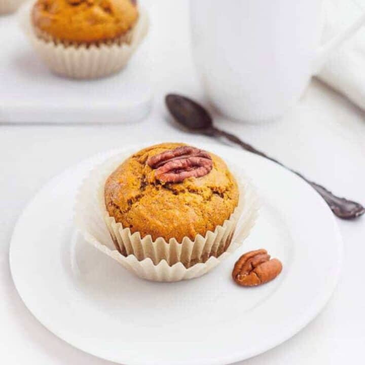 Sweet potato muffin on dish served with coffee.