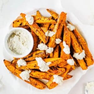 Baked sweet potato wedges topped with feta cheese.