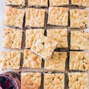 Blueberry jam and hazelnut bars on board.