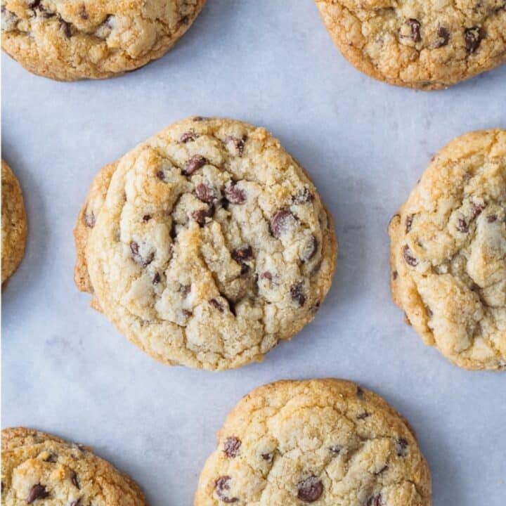 Baked chocolate chip cookies on baking sheet.