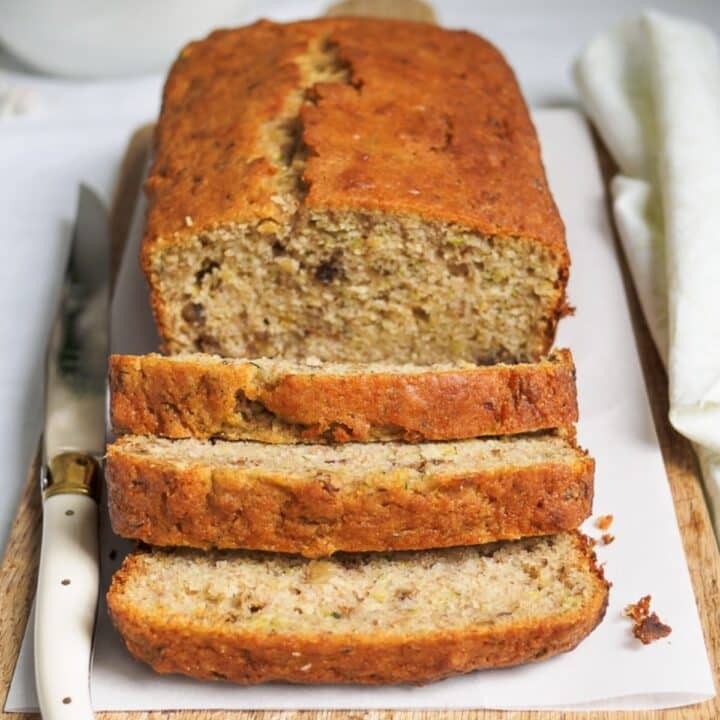 Sliced zucchini bread on cutting board.