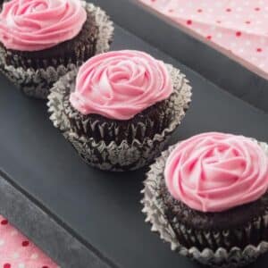 Chocolate beet cupcakes with cream cheese icing on serving tray.