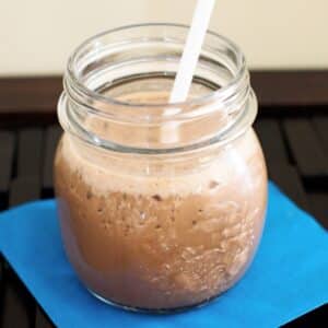 Coffee smoothie in small mason jar.