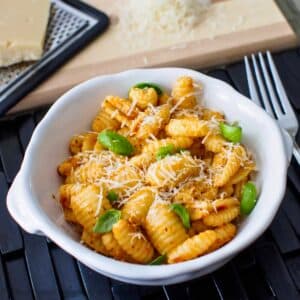 Bowl of pasta with a sun-dried tomato pesto.