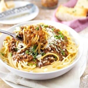 Bowl of spaghetti topped with meat sauce.