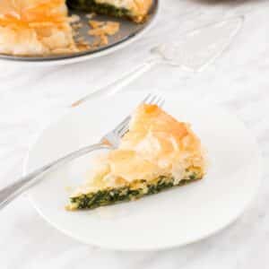 Slice of Spanakopita pie on plate.