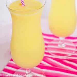 Two glasses of pineapple mango smoothie.