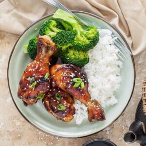 Plate of hoisin-soy marinated chicken drumsticks.