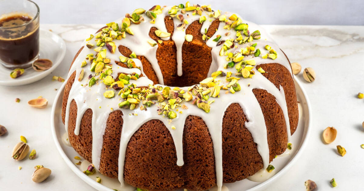 Glazed pistachio bundt cake on platter.