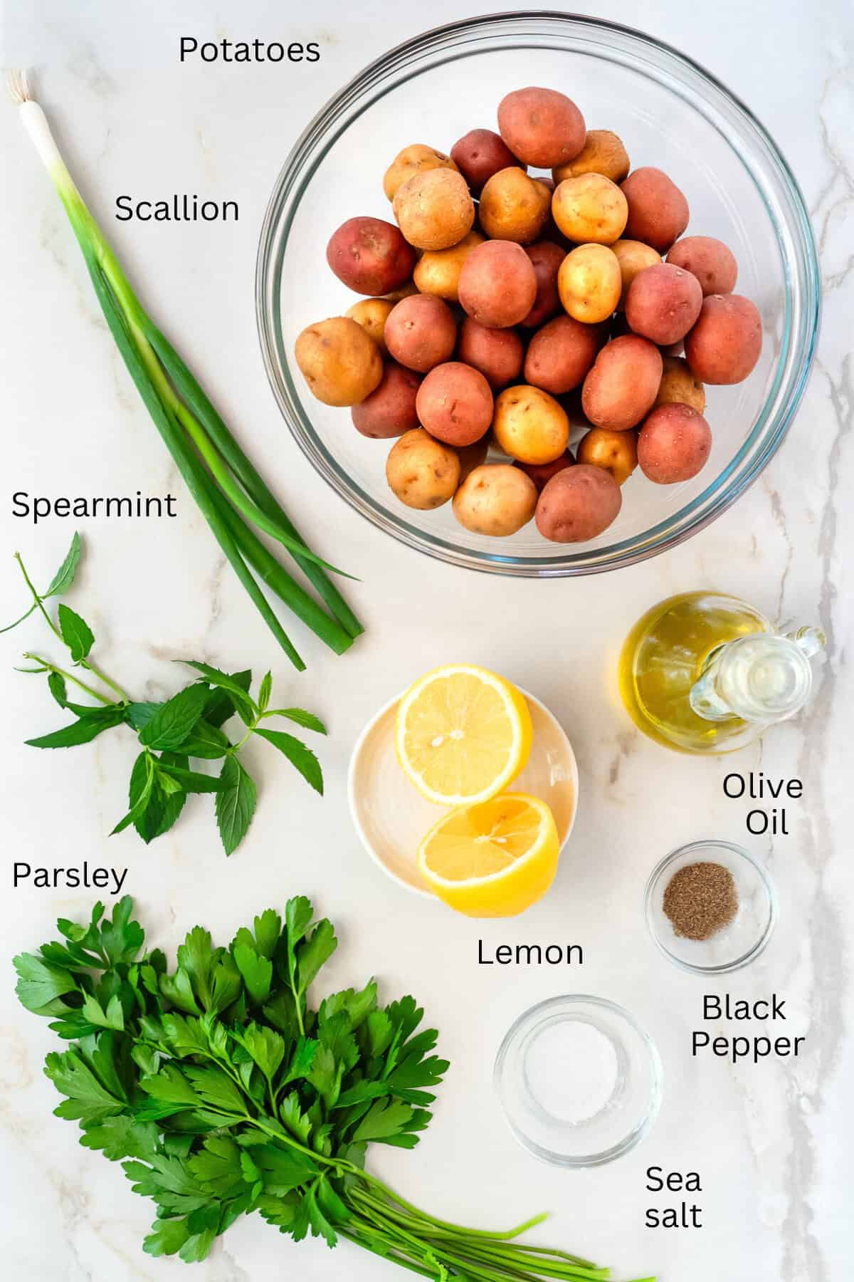 Ingredients for Lebanese potato salad, recipe includes potatoes, parsley, scallion, mint, lemon, olive oil, salt and pepper.