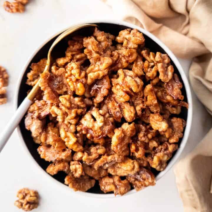 Bowl of maple spiced roasted walnuts.